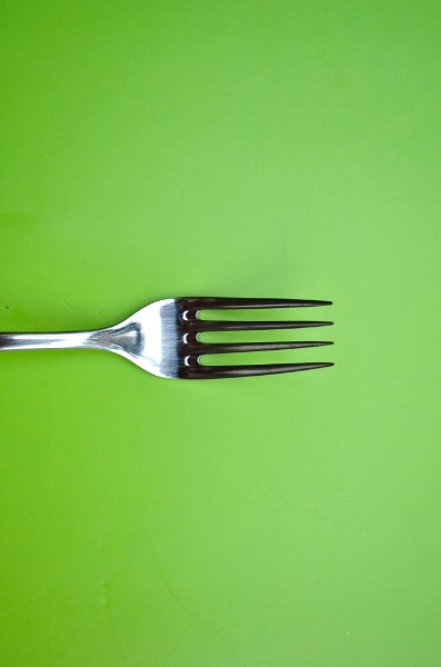 Fork on green background