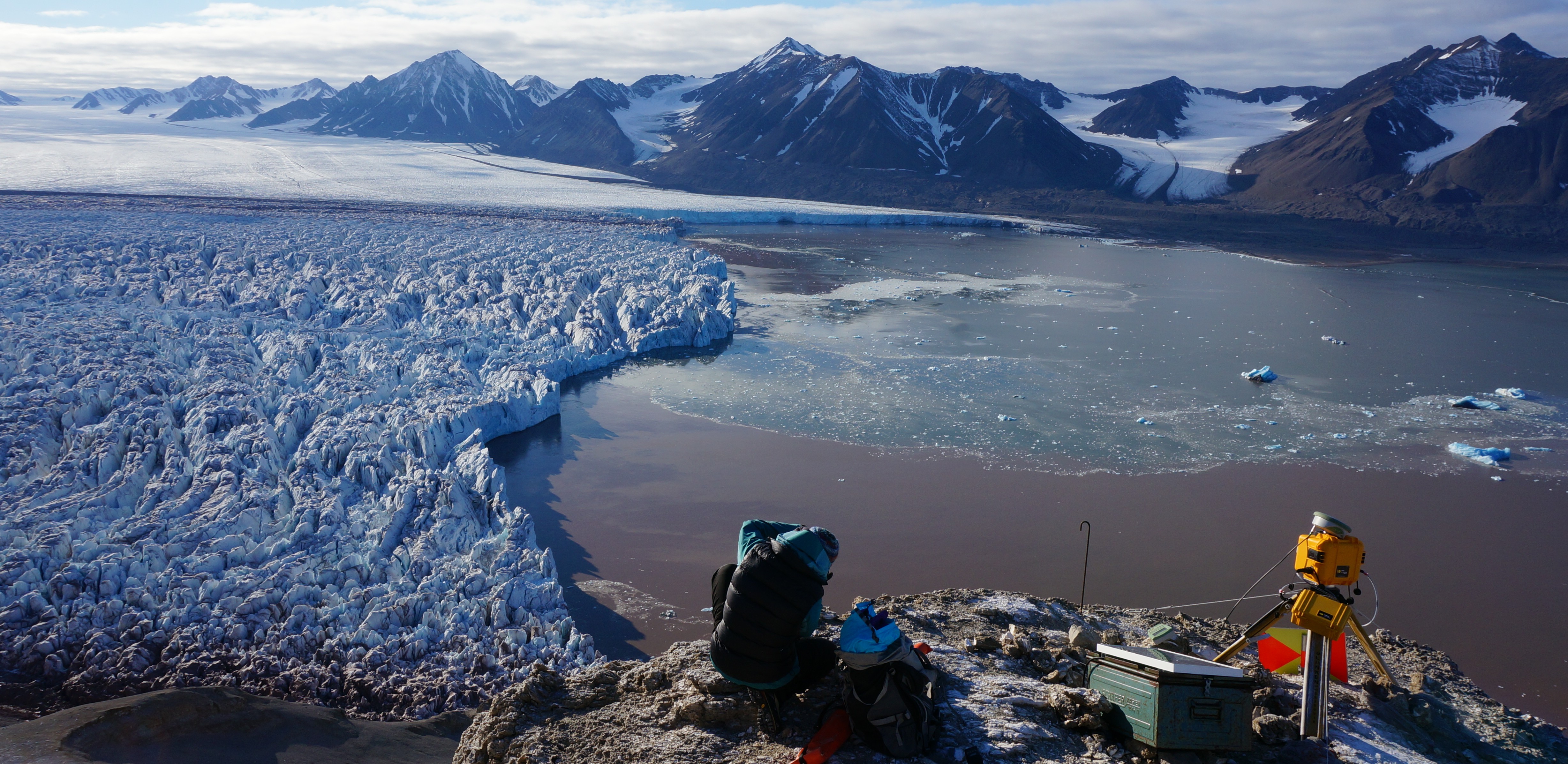 Post-doc researcher Sarah Thompson (UNIS) taking a GPS reading at camera site 2, positioned at the calving front of Kronebreen glacier, Svalbard (September 2015)