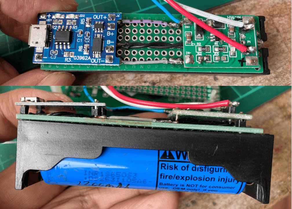 "TP4056 module and SD6201 boost converter soldered on the back of a prototype board which is used as the base of 18650 battery holder"