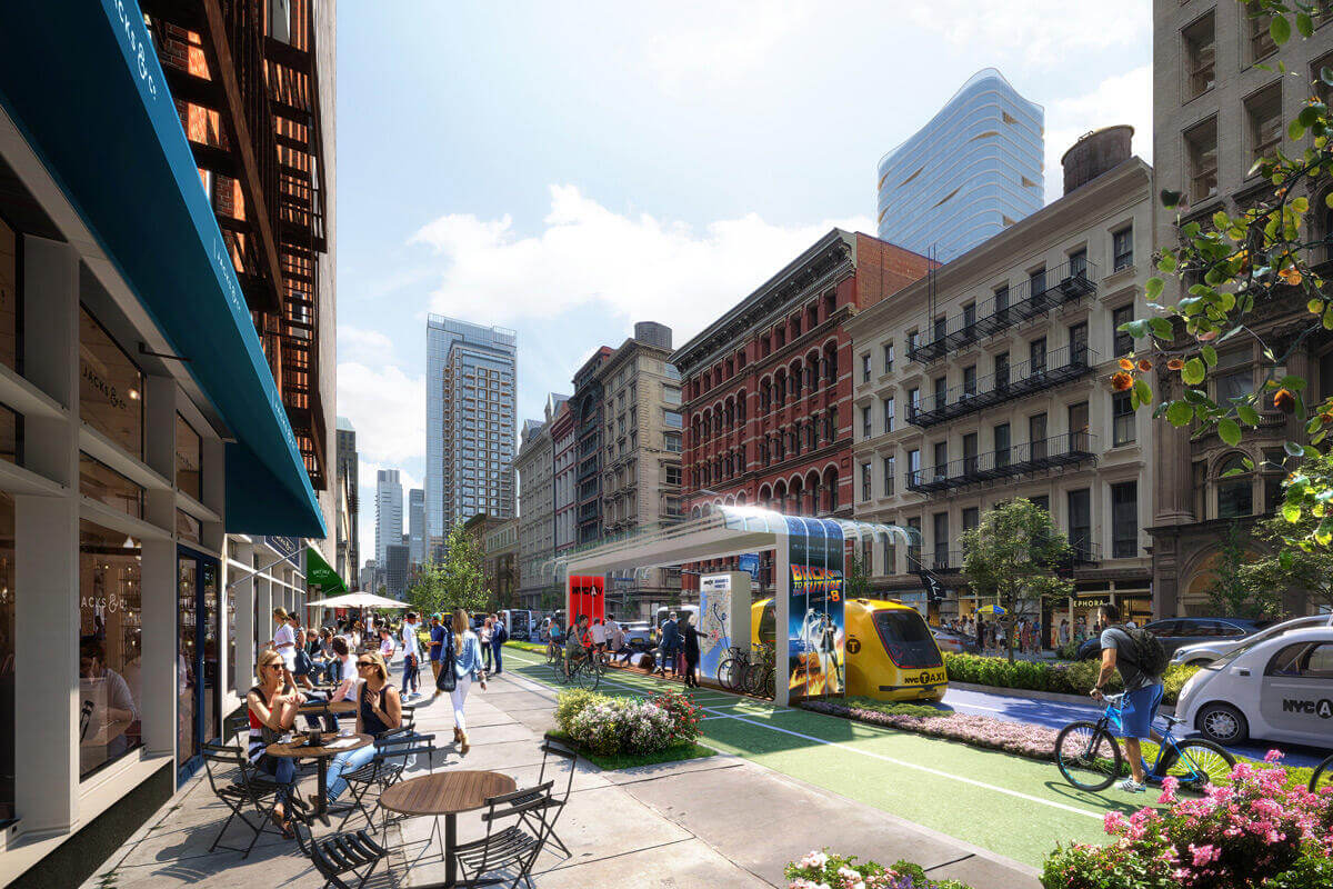 Rendering of a transformed street with ample sidewalk space for pedestrians and table seating, a green two-way bike lane protected by bioswales and a bus stop, more trees amidst the busy city center, and still room for car lanes. 