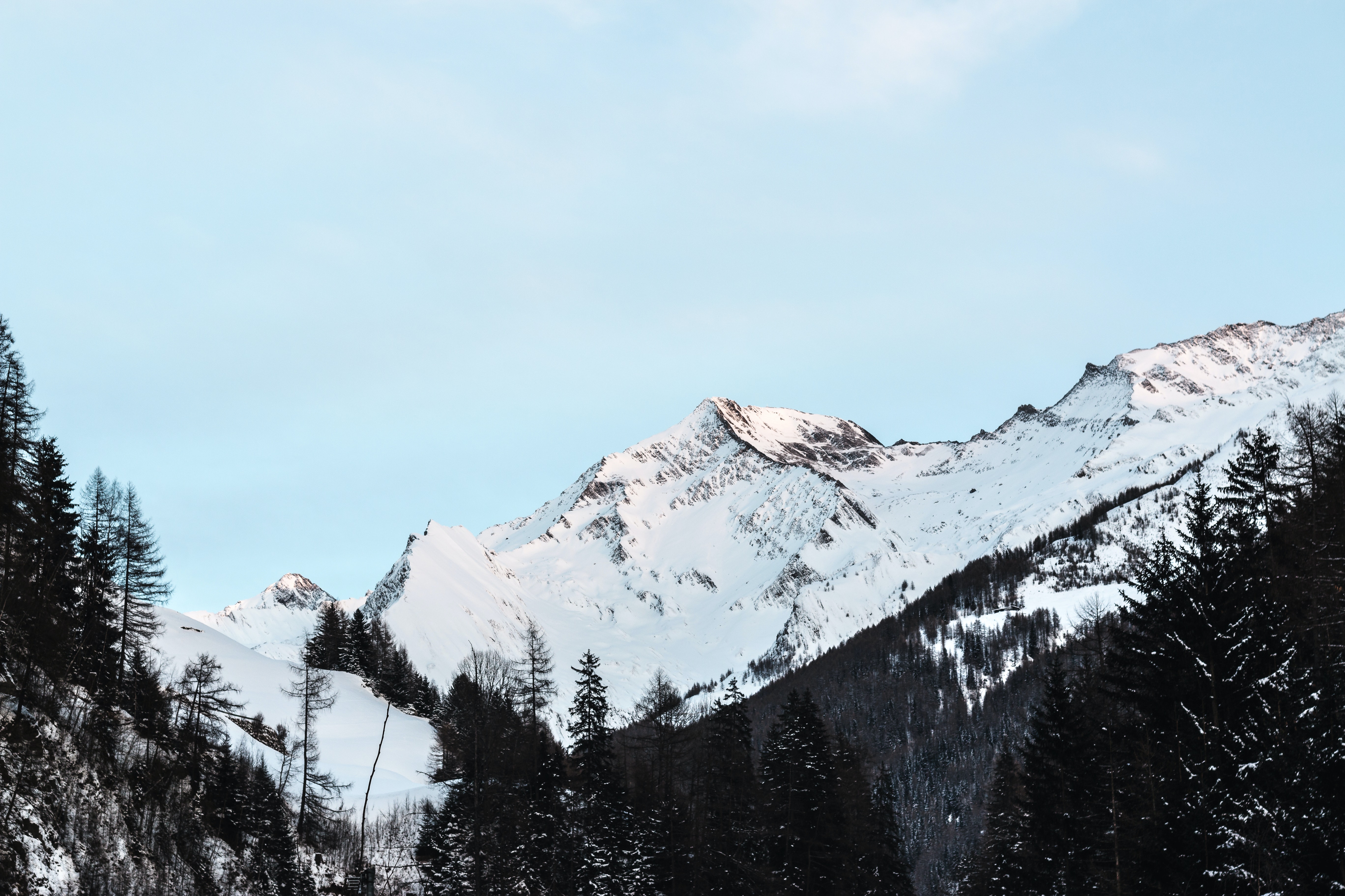 snow-covered-mountain-with-black-trees-under-blue-sky-at-712867.jpg