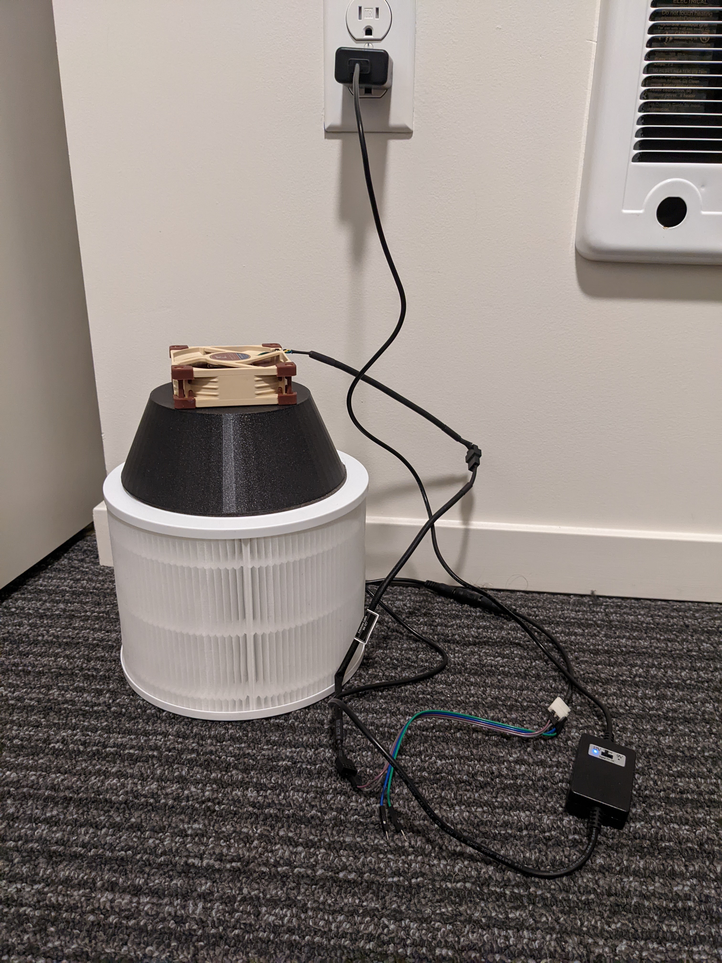 Air purifier on the floor plugged into the wall