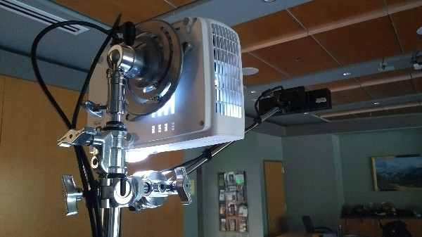 Back of a projector with a mount on a stand